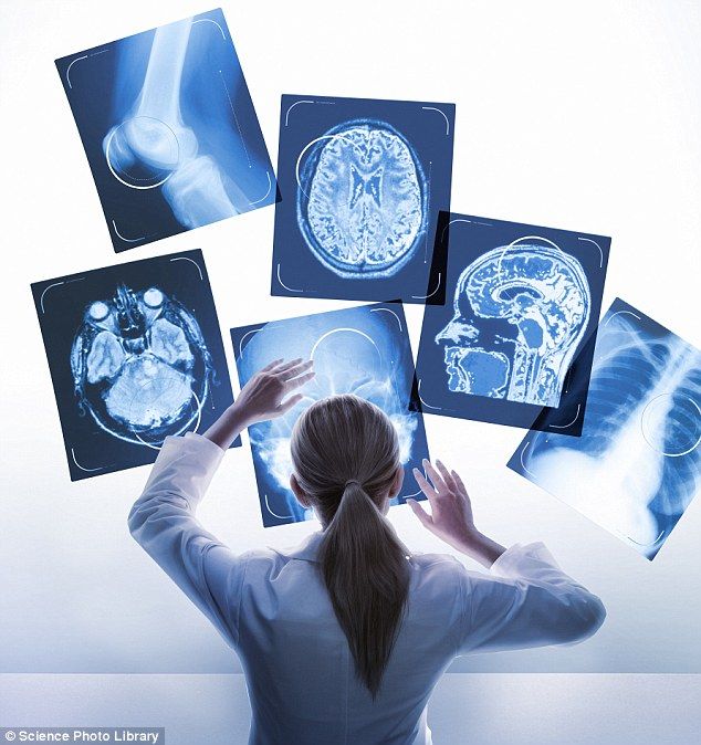 A clinician reviewing scans